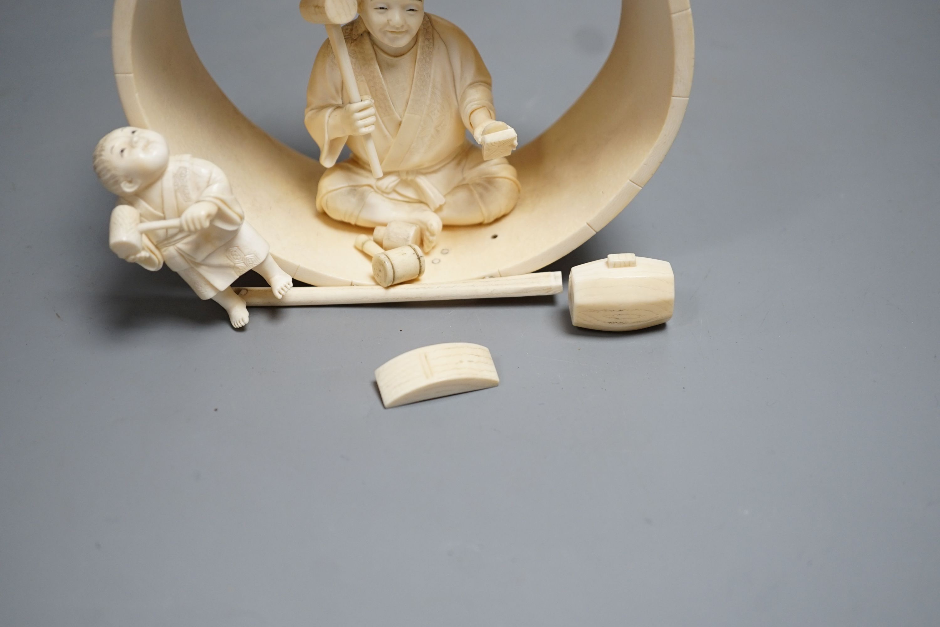 A Japanese ivory okimono of carpenter and child, Meiji period 15cm